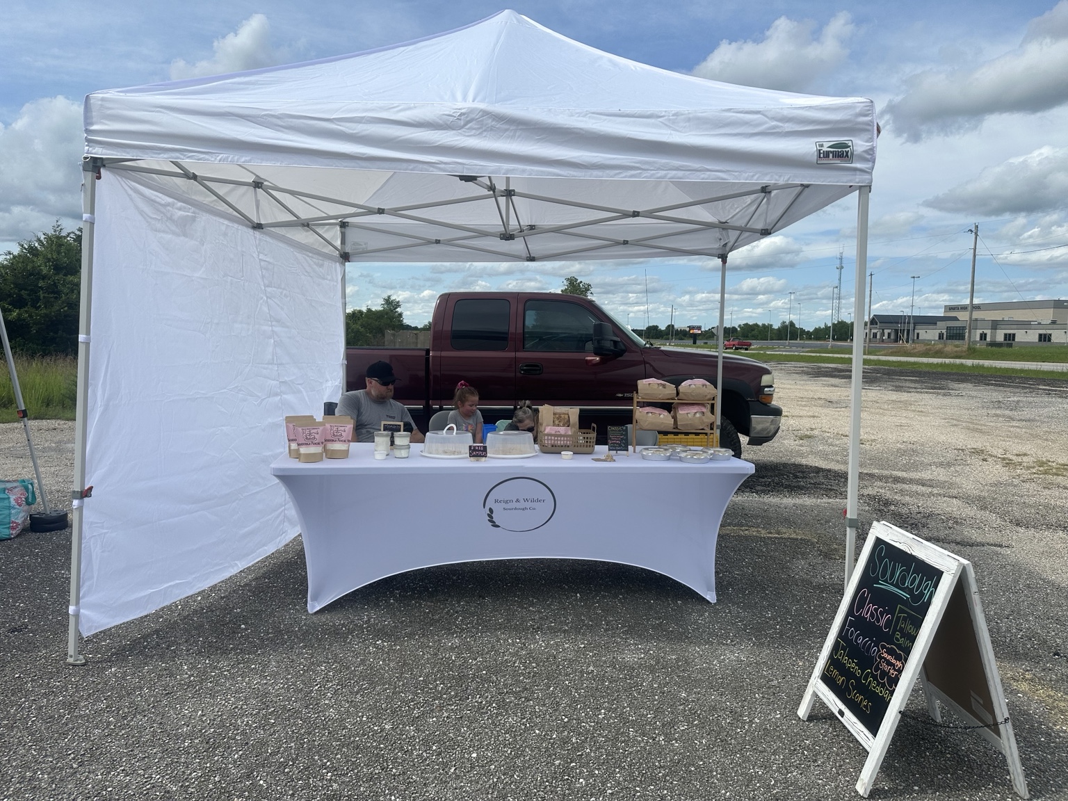 Reign & Wilder event booth with customers browsing baked goods at a local Missouri market